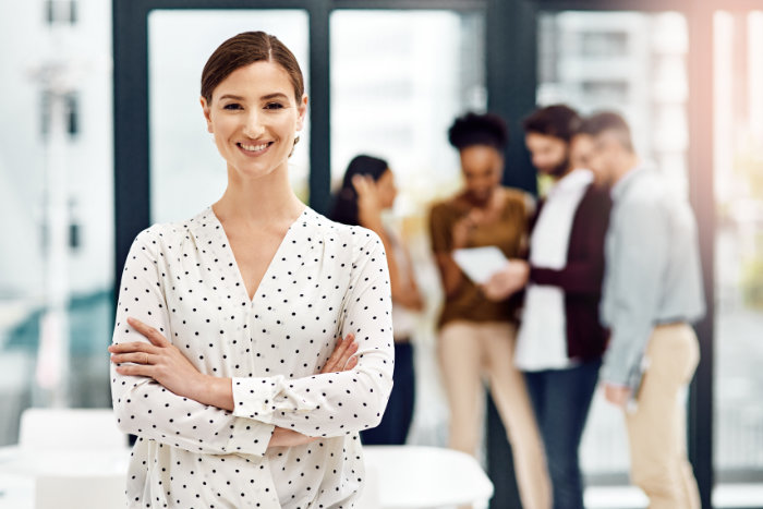 Arms crossed, leadership and portrait of business woman in office for creative or design occupation. Management, meeting and smile of confident employee in workplace boardroom for project management