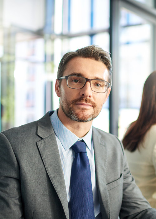 Portrait, business and man in meeting with confidence at consultant presentation in conference room. Leadership, opportunity and businessman at boardroom table for b2b project management in office.